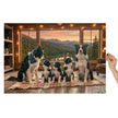 Border Collie Family Cabin Jigsaw Puzzle in Tin showing a cozy cabin scene with Border Collies and a mountain view.