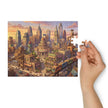 Person assembling Cat City Life Jigsaw Puzzle in Tin featuring lively illustrated city with cats, buildings, and trains.