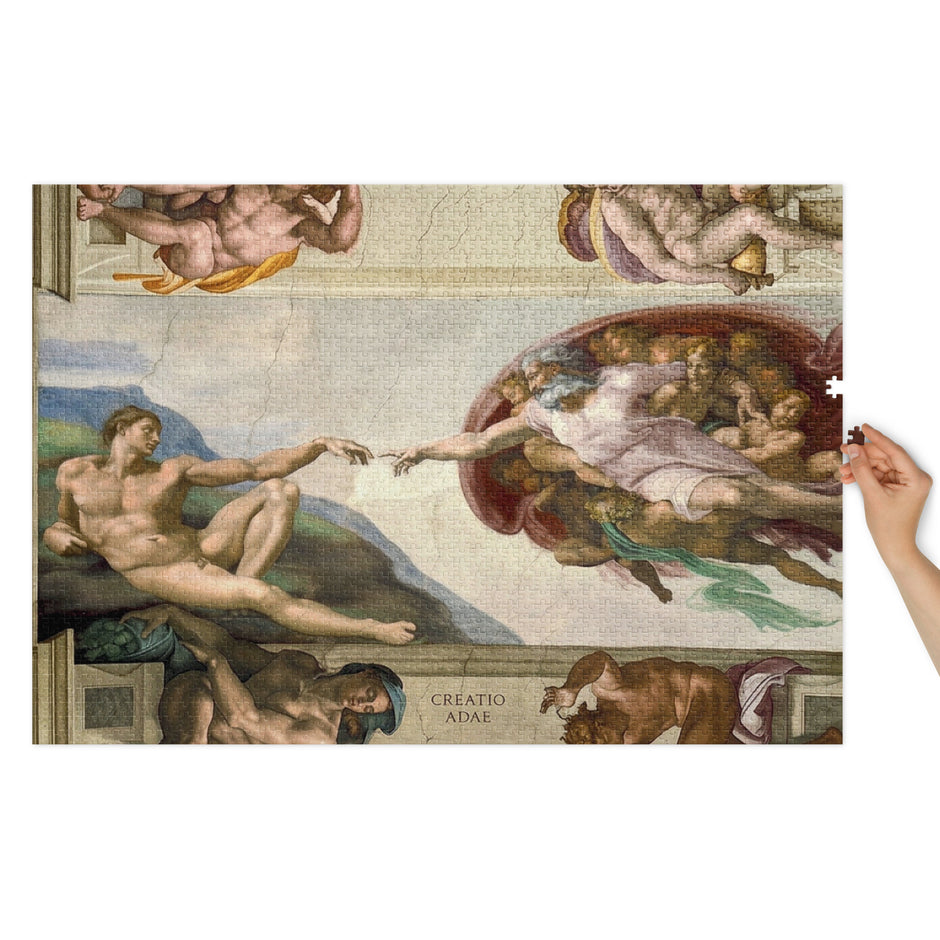 Creatio Adae (The Creation of Adam) Puzzle in Tin featuring Michelangelo's iconic fresco, held by hand, glossy finish.