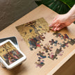 Assembling Crucifixion of Christ by Fra Angelico Puzzle in Tin on wooden table