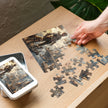 Dog Heaven Jigsaw Puzzle in Tin featuring a surreal steampunk scene with dogs and floating platforms being assembled
