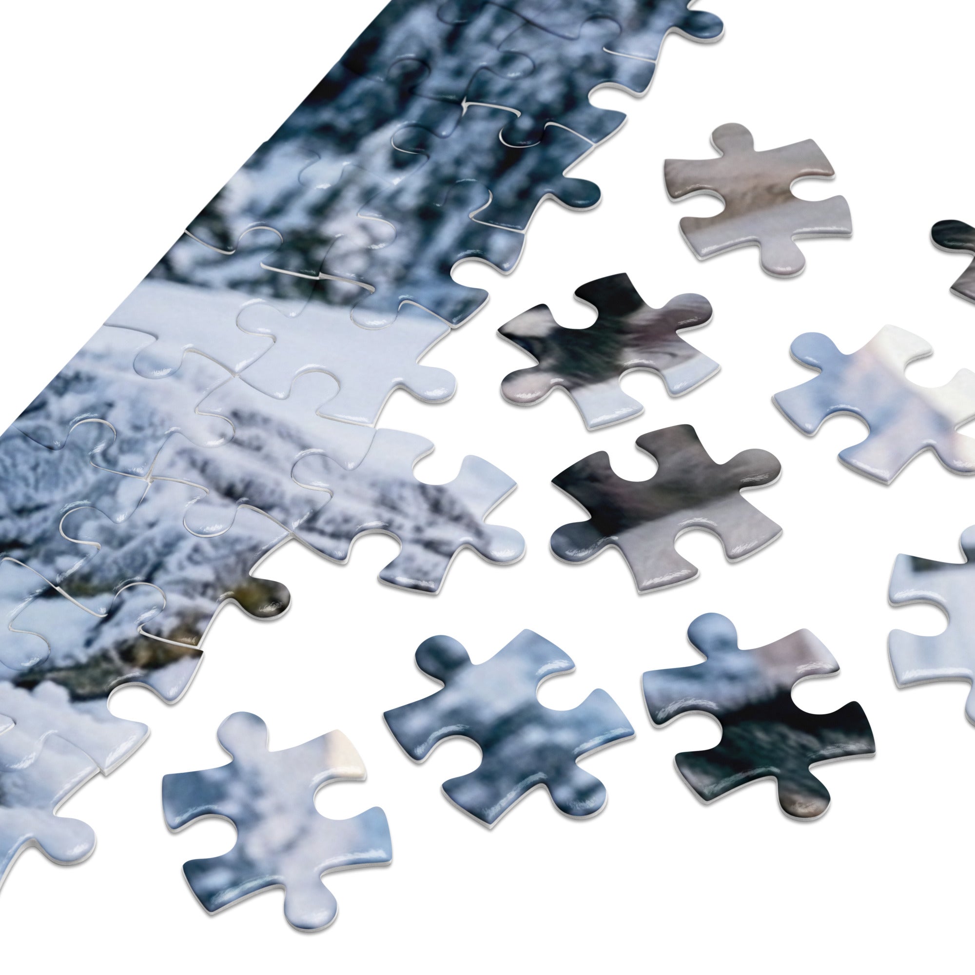 Close-up of Husky Family Winter Jigsaw Puzzle in Tin with puzzle pieces and snowy mountain design