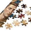 Modern Messiah Jigsaw Puzzle in Tin with detailed artwork depicting a symbolic desert scene and reimagined figure.