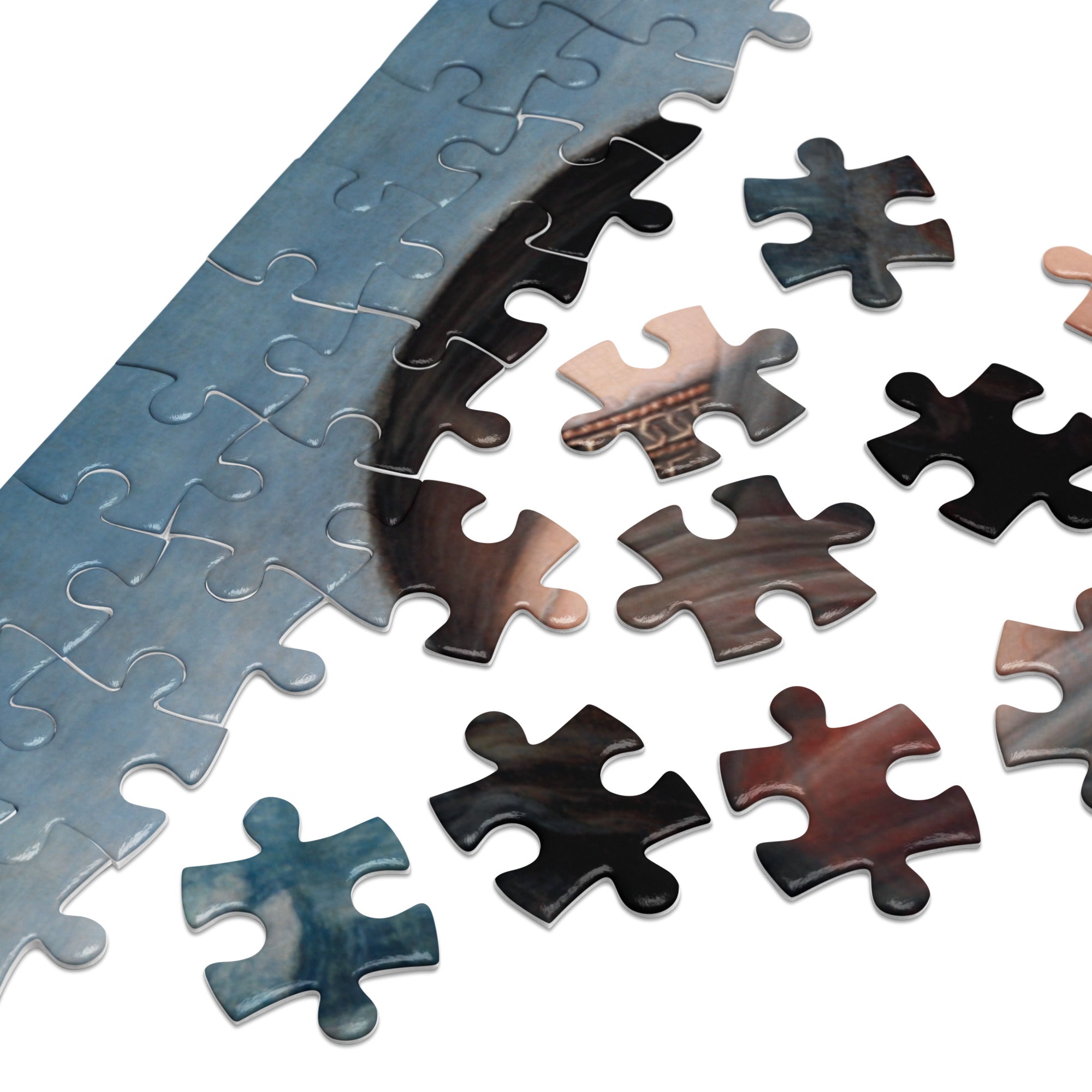 Close-up of scattered glossy puzzle pieces featuring the iconic Mona Lisa by Leonardo da Vinci Puzzle in Tin for art lovers.