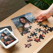 Mona Lisa by Leonardo da Vinci Puzzle in Tin with gloss finish and multiple sizes, displayed partially assembled on a wooden table.