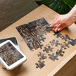 Assembling Mouse Market Town Jigsaw Puzzle in Tin with detailed miniature mice town scene.