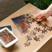 Nativity of Jesus by Bernardo Daddi Puzzle in Tin on table, glossy finish, pieces being assembled next to open tin with printed lid image